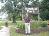 "Randall Romp" In Randall Park, a little north of the drinking fountain, on the ground, black vent looking object.  Solon, IA - 16 July 2007